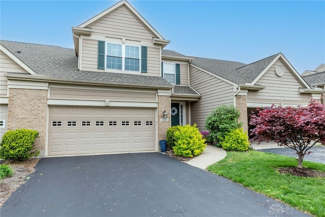 2540 Greenside Dr, Beavercreek, OH 45431 - traditional-style house with driveway, brick siding, roof with shingles, and an attached garage