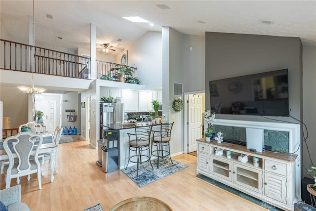 2540 Greenside Dr, Beavercreek, OH 45431 - living area featuring high vaulted ceiling, light wood-style floors, and a ceiling fan