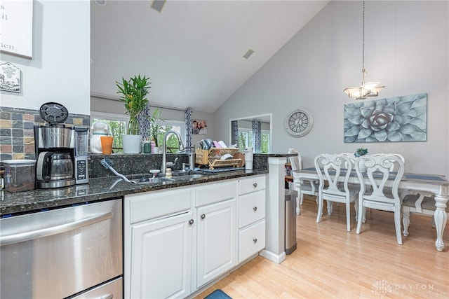 2540 Greenside Dr, Beavercreek, OH 45431 - kitchen with dishwasher, light wood-style flooring, white cabinets, dark stone countertops, and a peninsula