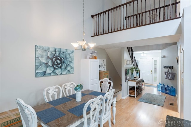 2540 Greenside Dr, Beavercreek, OH 45431 - dining room with light wood-type flooring and a towering ceiling
