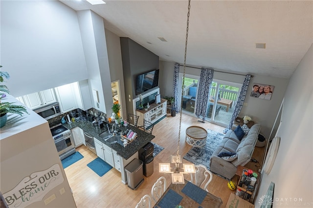 2540 Greenside Dr, Beavercreek, OH 45431 - living room with light wood-style floors and high vaulted ceiling