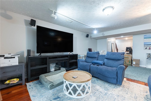 2540 Greenside Dr, Beavercreek, OH 45431 - living room featuring wood finished floors, a textured ceiling, and rail lighting