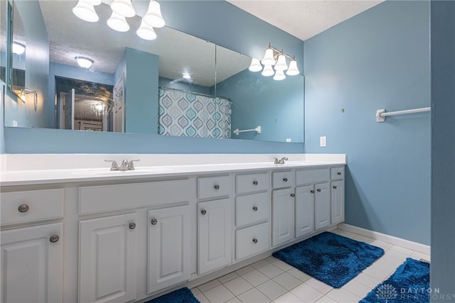 2540 Greenside Dr, Beavercreek, OH 45431 - bathroom featuring tile patterned floors, a textured ceiling, double vanity, a shower with curtain, and baseboards