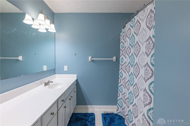2540 Greenside Dr, Beavercreek, OH 45431 - full bath featuring tile patterned floors, vanity, a textured ceiling, baseboards, and curtained shower