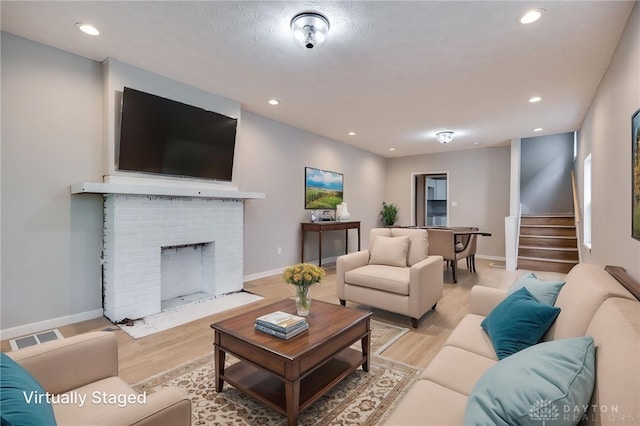 18241826 W Grand Ave, Dayton, OH 45402 - living room featuring light wood-type flooring, recessed lighting, stairway, baseboards, and a brick fireplace