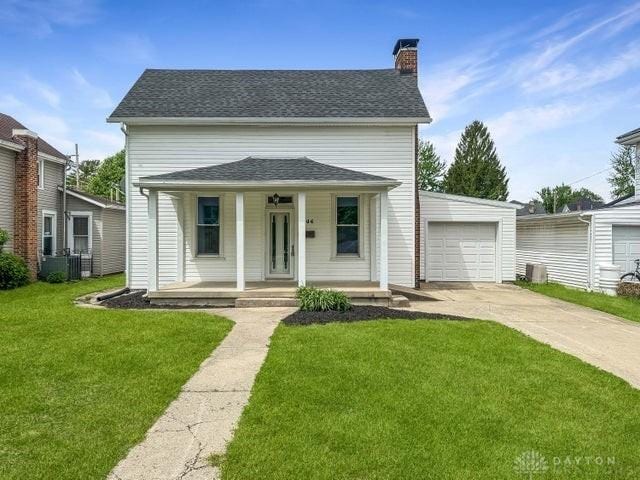 244 Windsor Ave, Urbana, OH 43078 - view of front of property featuring covered porch, a chimney, concrete driveway, a front yard, and central AC