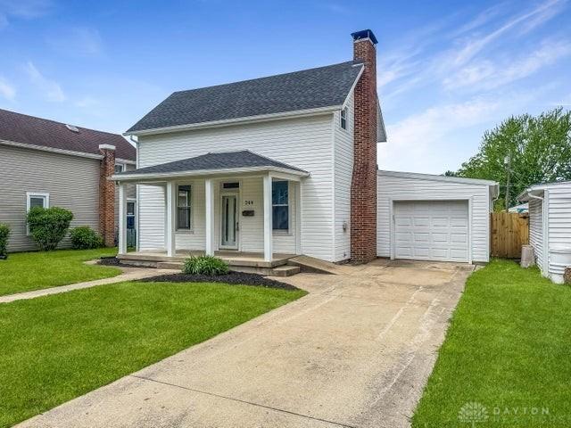 244 Windsor Ave, Urbana, OH 43078 - view of front of property featuring covered porch, concrete driveway, a chimney, and a garage