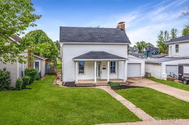 244 Windsor Ave, Urbana, OH 43078 - view of front facade with covered porch, driveway, a chimney, and a garage