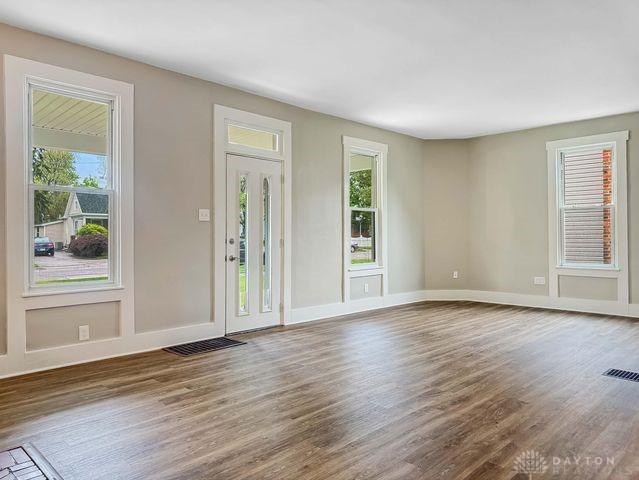 244 Windsor Ave, Urbana, OH 43078 - unfurnished living room featuring healthy amount of natural light, wood finished floors, and baseboards