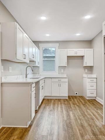 244 Windsor Ave, Urbana, OH 43078 - kitchen featuring a sink, light wood-style floors, white cabinetry, light countertops, and recessed lighting