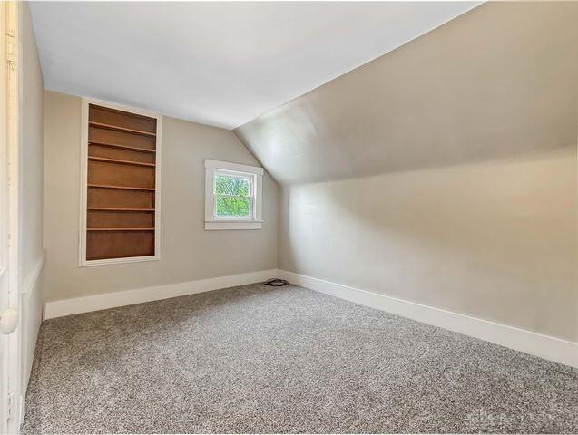 244 Windsor Ave, Urbana, OH 43078 - bonus room with carpet flooring, vaulted ceiling, baseboards, and built in shelves
