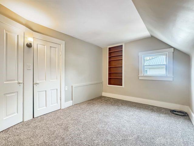 244 Windsor Ave, Urbana, OH 43078 - bonus room featuring vaulted ceiling, carpet flooring, baseboards, and built in shelves