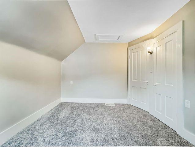 244 Windsor Ave, Urbana, OH 43078 - bonus room with carpet floors, vaulted ceiling, attic access, and baseboards