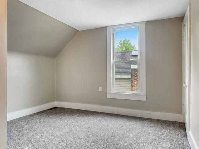 244 Windsor Ave, Urbana, OH 43078 - bonus room with baseboards, lofted ceiling, and carpet flooring
