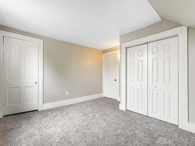 244 Windsor Ave, Urbana, OH 43078 - unfurnished bedroom with carpet flooring, a closet, and baseboards