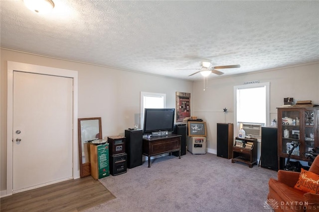 office area with healthy amount of natural light, a ceiling fan, a textured ceiling, crown molding, and baseboards