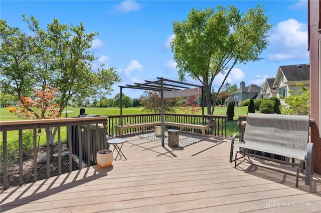 wooden terrace featuring a pergola and a lawn