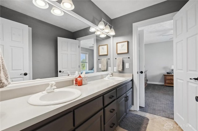 ensuite bathroom with double vanity and tile patterned flooring