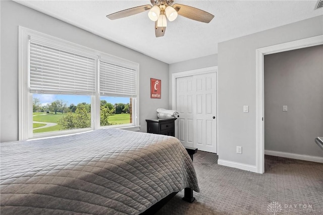 bedroom featuring carpet, baseboards, a ceiling fan, and a closet