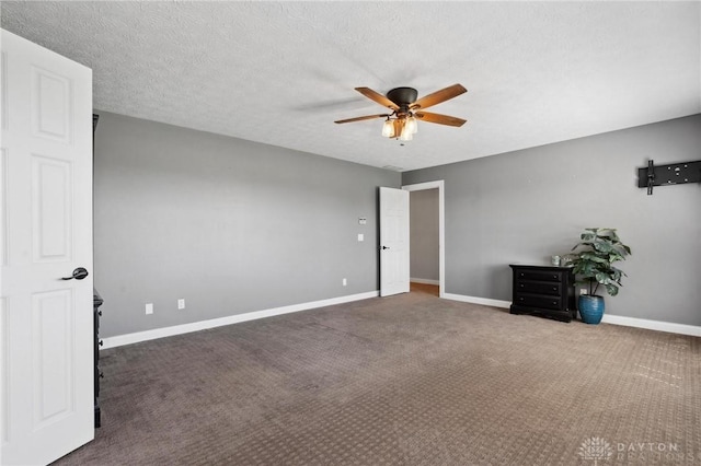 unfurnished bedroom with carpet floors, baseboards, and a ceiling fan