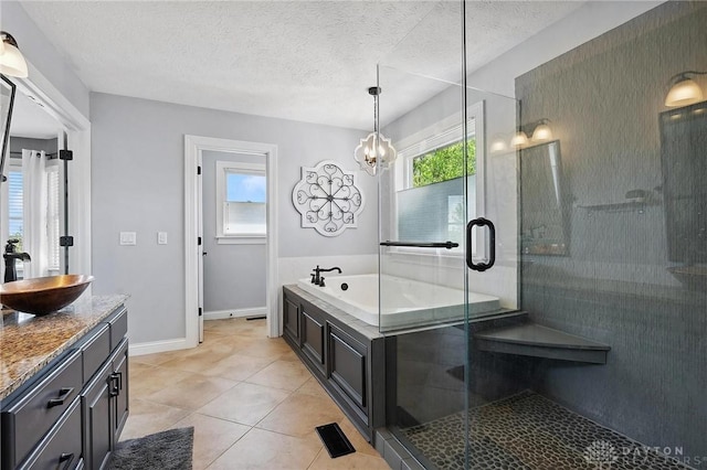 full bath featuring a shower stall, tile patterned floors, a bath, vanity, and a textured ceiling