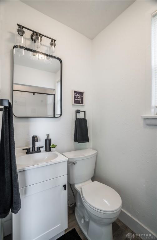 221 Virginia Ave, Dayton, OH 45410 - half bathroom featuring vanity and wood finished floors