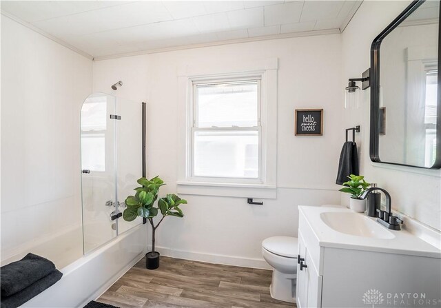 221 Virginia Ave, Dayton, OH 45410 - full bathroom with crown molding, vanity, wood finished floors, and shower / bath combination