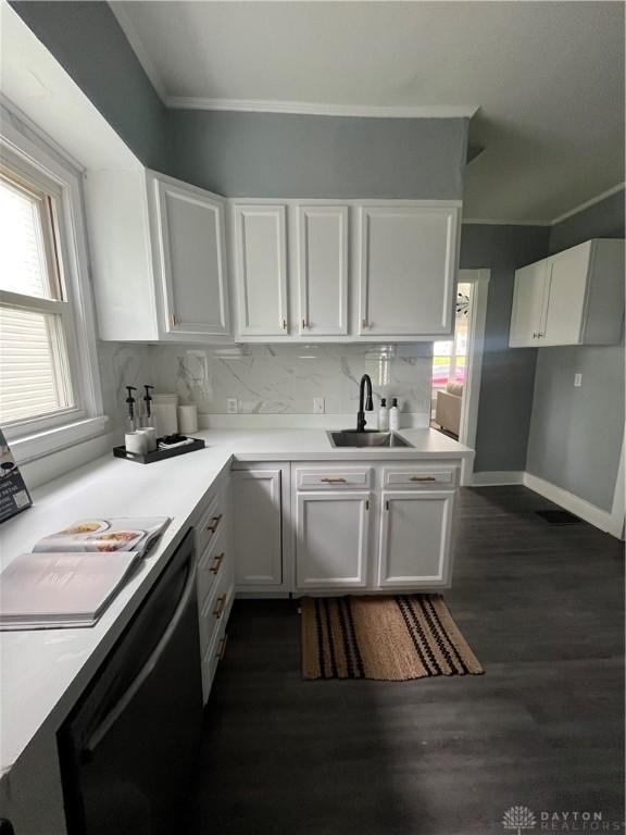 221 Virginia Ave, Dayton, OH 45410 - kitchen featuring white cabinets, crown molding, light countertops, dishwasher, and dark wood-type flooring