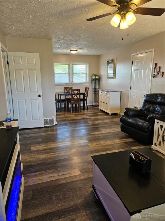 5107 Christy Ave, Dayton, OH 45431 - living area with a textured ceiling, dark wood finished floors, and ceiling fan