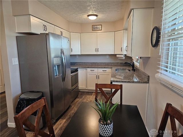 5107 Christy Ave, Dayton, OH 45431 - kitchen featuring stainless steel appliances, a textured ceiling, dark wood-style flooring, a sink, and white cabinets