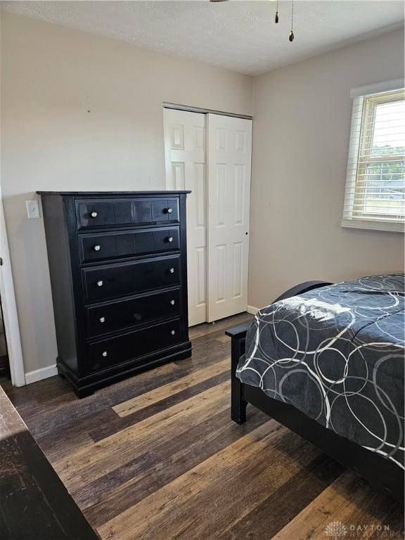 5107 Christy Ave, Dayton, OH 45431 - bedroom featuring dark wood finished floors, baseboards, a closet, and a textured ceiling