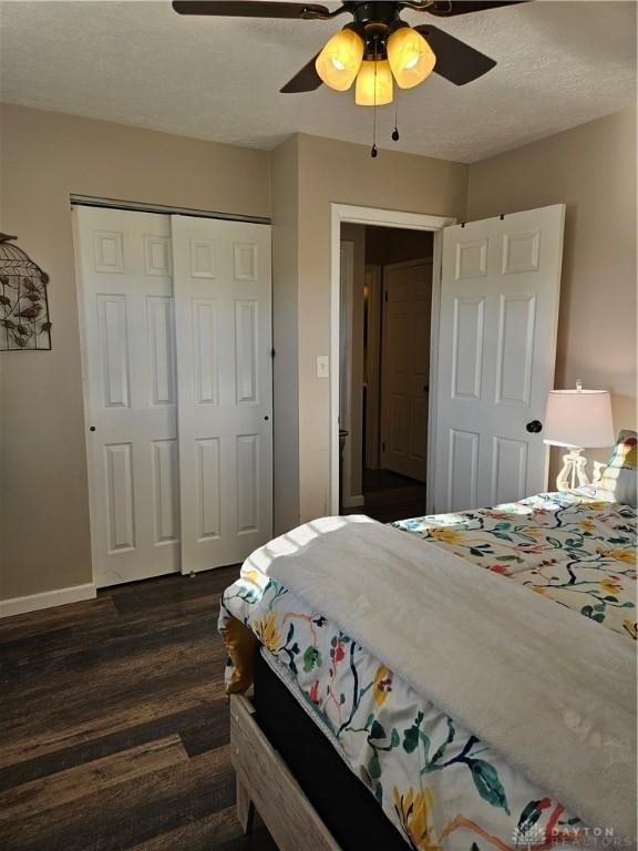5107 Christy Ave, Dayton, OH 45431 - bedroom with dark wood-style flooring, a closet, baseboards, ceiling fan, and a textured ceiling