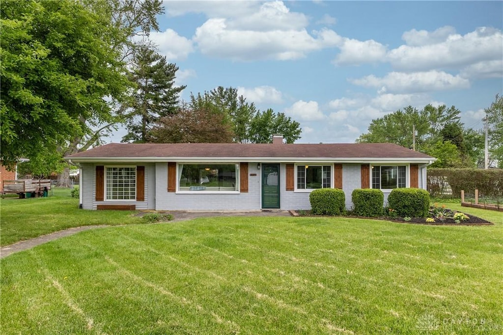 3085 Wolfe Dr, Fairborn, OH 45324 - ranch-style house with a front yard, a chimney, and brick siding