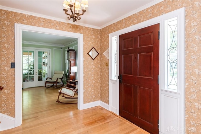 135 E Dixon Ave, Oakwood, OH 45419 - entrance foyer with light wood-style flooring, a chandelier, ornamental molding, and wallpapered walls