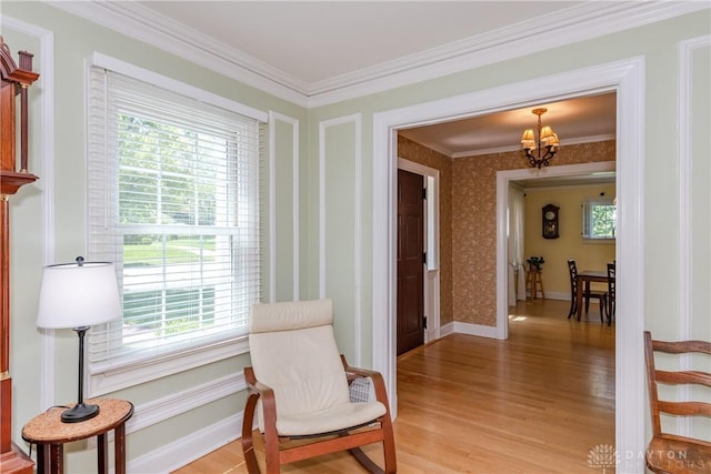 135 E Dixon Ave, Oakwood, OH 45419 - sitting room featuring a chandelier, plenty of natural light, light wood-style flooring, and ornamental molding