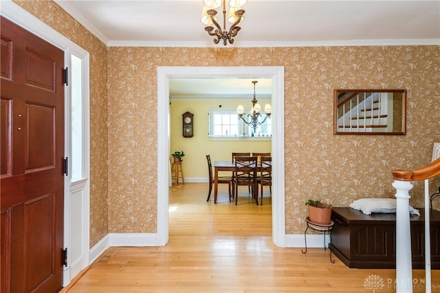 135 E Dixon Ave, Oakwood, OH 45419 - entrance foyer featuring a chandelier, wood finished floors, wallpapered walls, baseboards, and ornamental molding