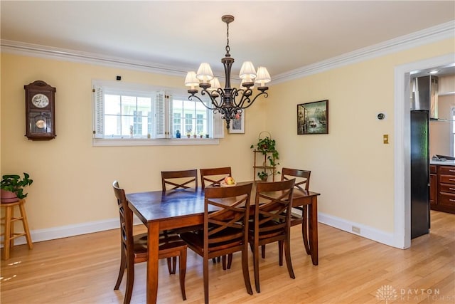 135 E Dixon Ave, Oakwood, OH 45419 - dining room featuring light wood-type flooring, ornamental molding, a chandelier, and baseboards