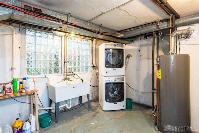 135 E Dixon Ave, Oakwood, OH 45419 - basement with stacked washing machine and dryer, water heater, and a sink