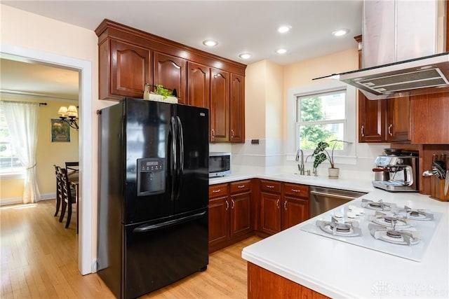 135 E Dixon Ave, Oakwood, OH 45419 - kitchen with stainless steel appliances, island exhaust hood, a sink, light countertops, and light wood-style flooring