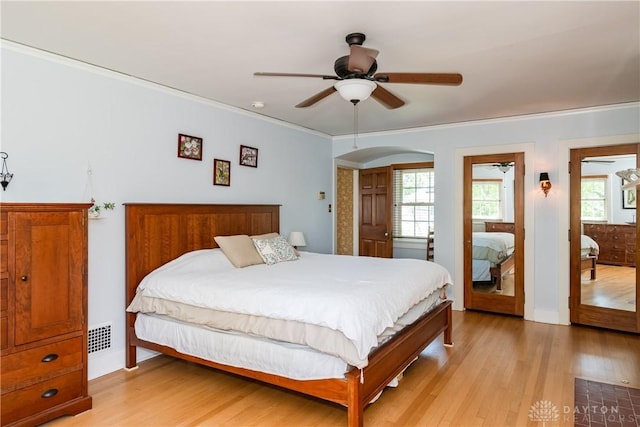 135 E Dixon Ave, Oakwood, OH 45419 - bedroom featuring light wood-style floors, crown molding, arched walkways, and ceiling fan