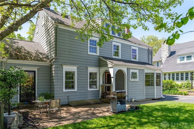 135 E Dixon Ave, Oakwood, OH 45419 - rear view of property featuring a patio area, a lawn, and a chimney