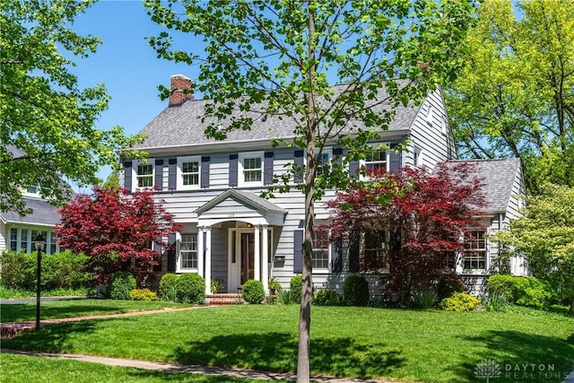 135 E Dixon Ave, Oakwood, OH 45419 - colonial house with a front yard and a chimney