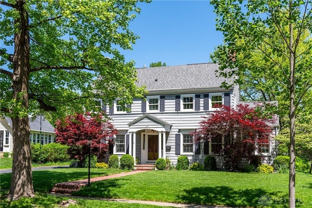 135 E Dixon Ave, Oakwood, OH 45419 - colonial house with a front lawn and roof with shingles