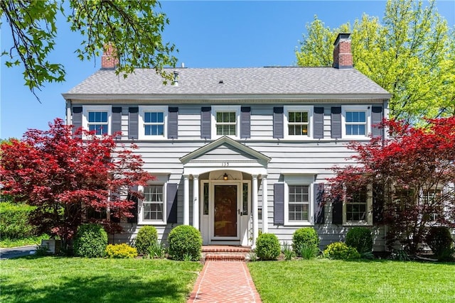 135 E Dixon Ave, Oakwood, OH 45419 - colonial house with a chimney, a front yard, and roof with shingles