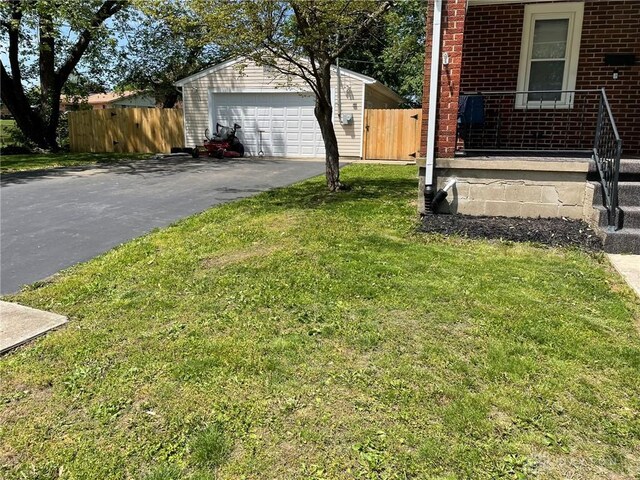 12 Harshman St, Brookville, OH 45309 - view of yard featuring driveway and a garage