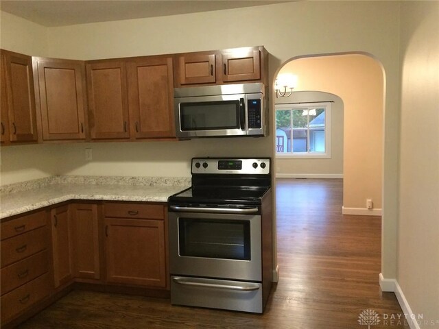 12 Harshman St, Brookville, OH 45309 - kitchen featuring appliances with stainless steel finishes, dark wood-type flooring, light countertops, and baseboards