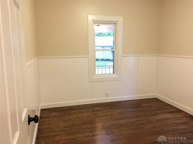 12 Harshman St, Brookville, OH 45309 - spare room with wainscoting and dark wood-style floors