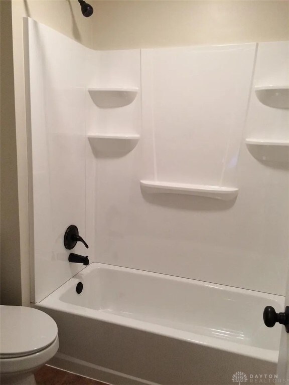 12 Harshman St, Brookville, OH 45309 - bathroom featuring toilet and shower / bathtub combination