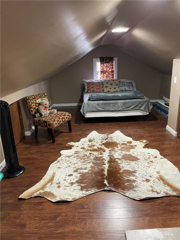 12 Harshman St, Brookville, OH 45309 - bedroom with baseboards, wood finished floors, and lofted ceiling