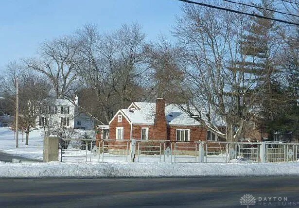 12 Harshman St, Brookville, OH 45309 - view of front of property featuring a fenced front yard and a chimney